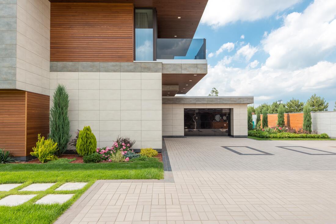 A stamped concrete driveway leads to a modern home. 