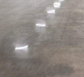 A polished concrete floor with reflecting lights